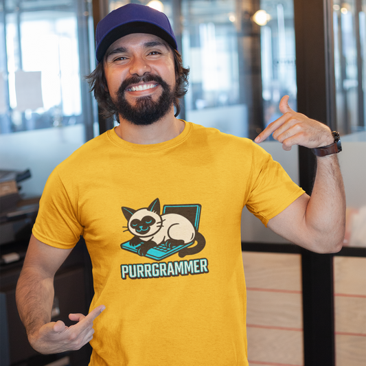 Man wearing a yellow t-shirt with a cat graphic and 'Purrgrammer' text, posing indoors.