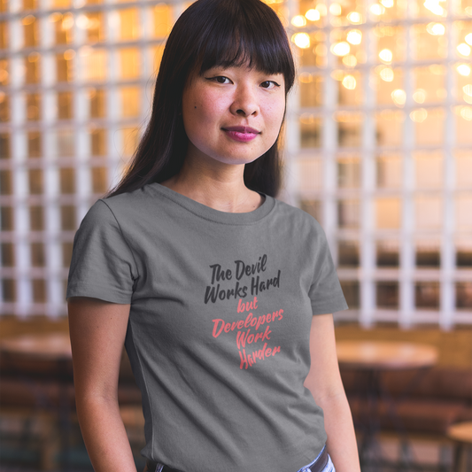 Person wearing a gray t-shirt with text in a casual setting