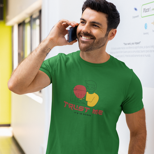 Man wearing a green t-shirt with a graphic design and text, standing in an indoor setting.