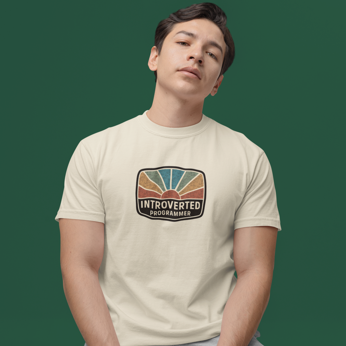 Person wearing a t-shirt with 'Introverted Programmer' design on a green background