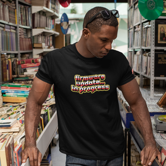 Man wearing a black t-shirt with colorful text in a bookstore