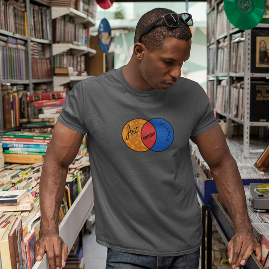 Man wearing a gray t-shirt with a colorful logo in a bookstore