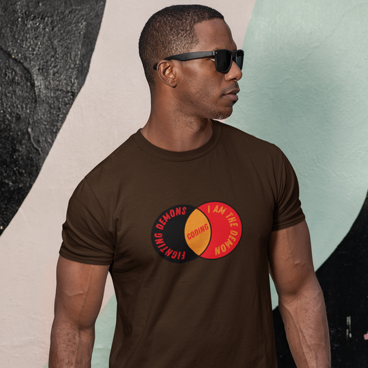 Man wearing a brown t-shirt with a colorful graphic design against a abstract wall.