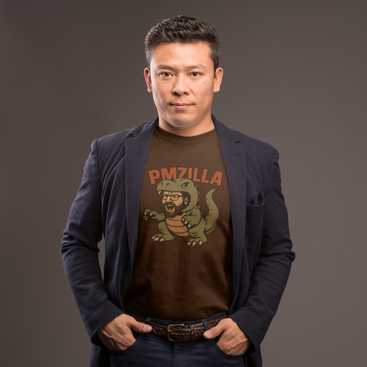 Man wearing a dark blazer over a graphic t-shirt with a logo on a gray background