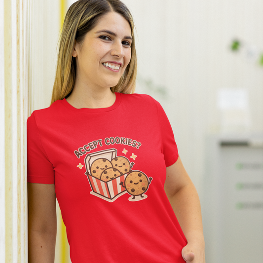 Woman wearing a red t-shirt with a cookie and popcorn design, standing in a kitchen.