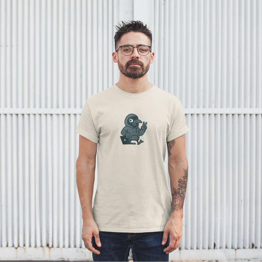 Man wearing a beige t-shirt with a graphic design in front of a white metal fence.