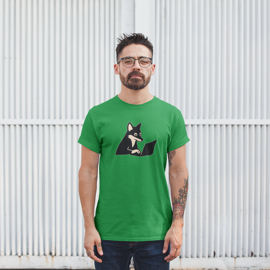 Man wearing a green t-shirt with a graphic design of a dog, standing against a white metal fence.