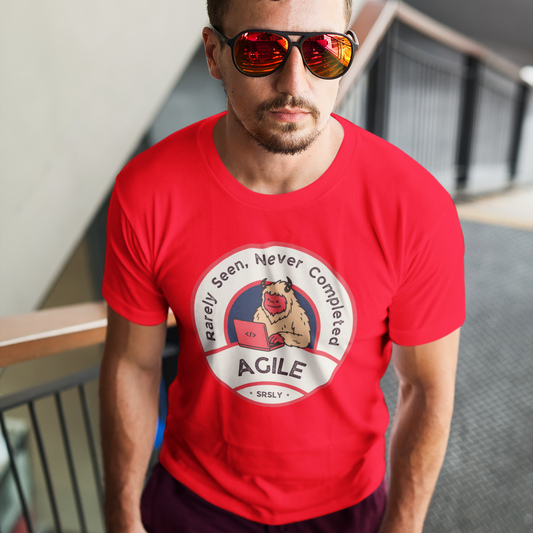 Man wearing a red t-shirt with a graphic design, standing on a staircase.