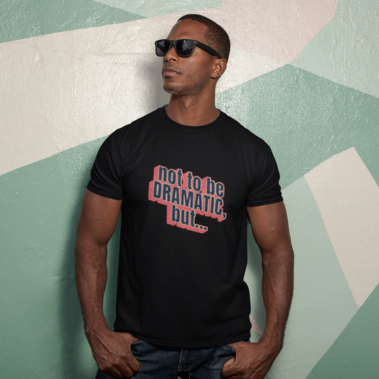 Man wearing a black t-shirt with text against a geometric-patterned wall