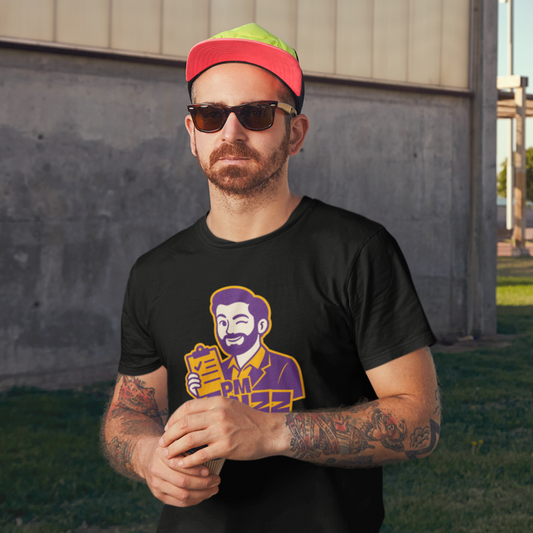 Man wearing a black t-shirt with a graphic design, sunglasses, and a colorful cap in an outdoor setting.