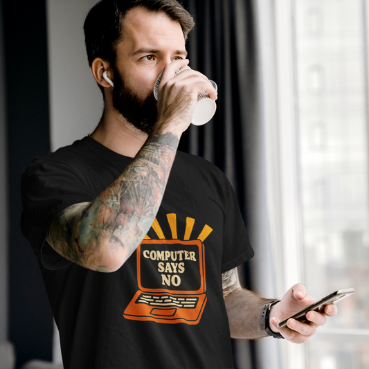 Man drinking from a cup while holding a phone, wearing a black t-shirt with a graphic design.