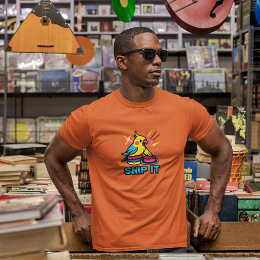 Man wearing an orange t-shirt with a colorful graphic design in a music store.