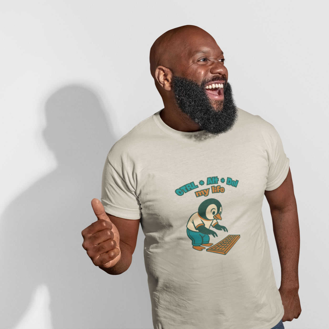 Man wearing a t-shirt with a graphic design and text, giving a thumbs-up gesture.