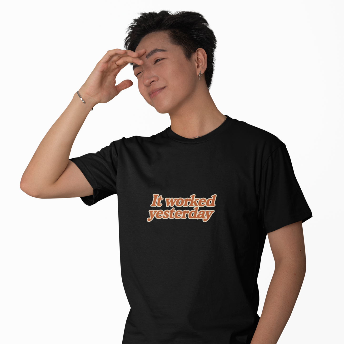 Person wearing a black t-shirt with 'It worked yesterday' text on a white background