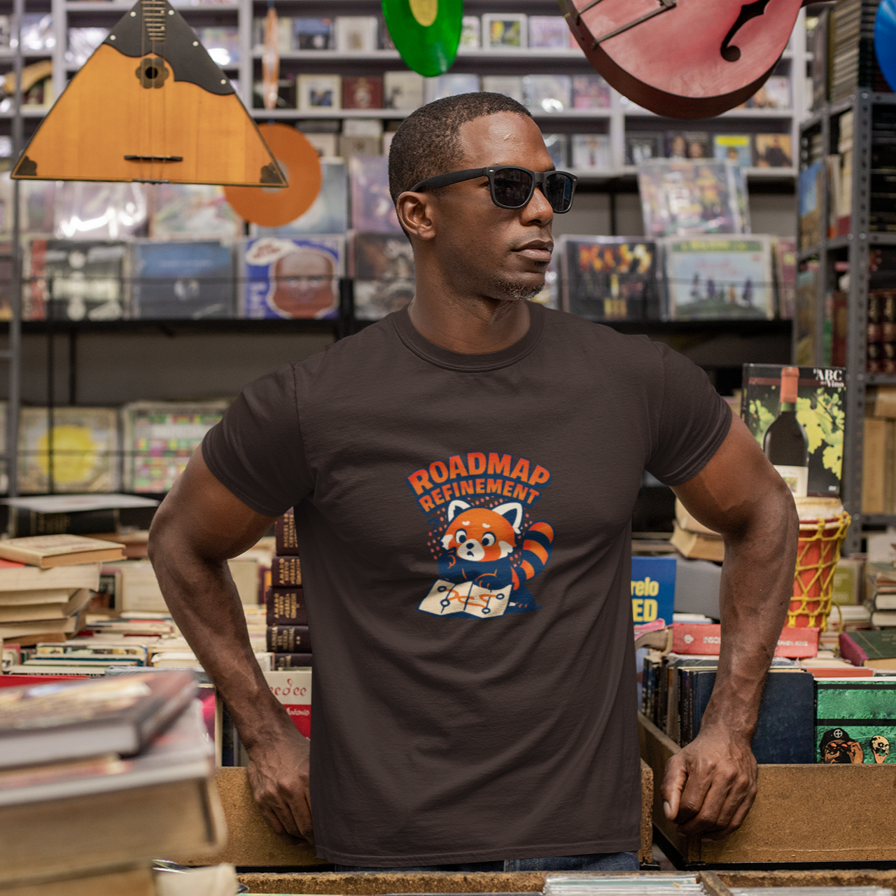 Man wearing a t-shirt with a graphic design in a store with books and musical instruments.