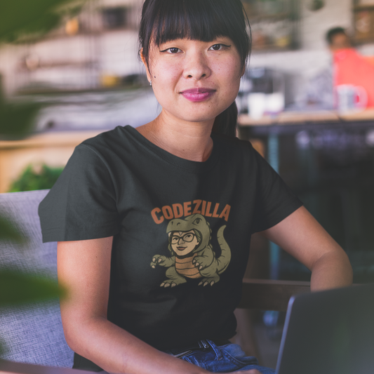 Person wearing a black t-shirt with 'Codezilla' graphic, sitting at a desk.