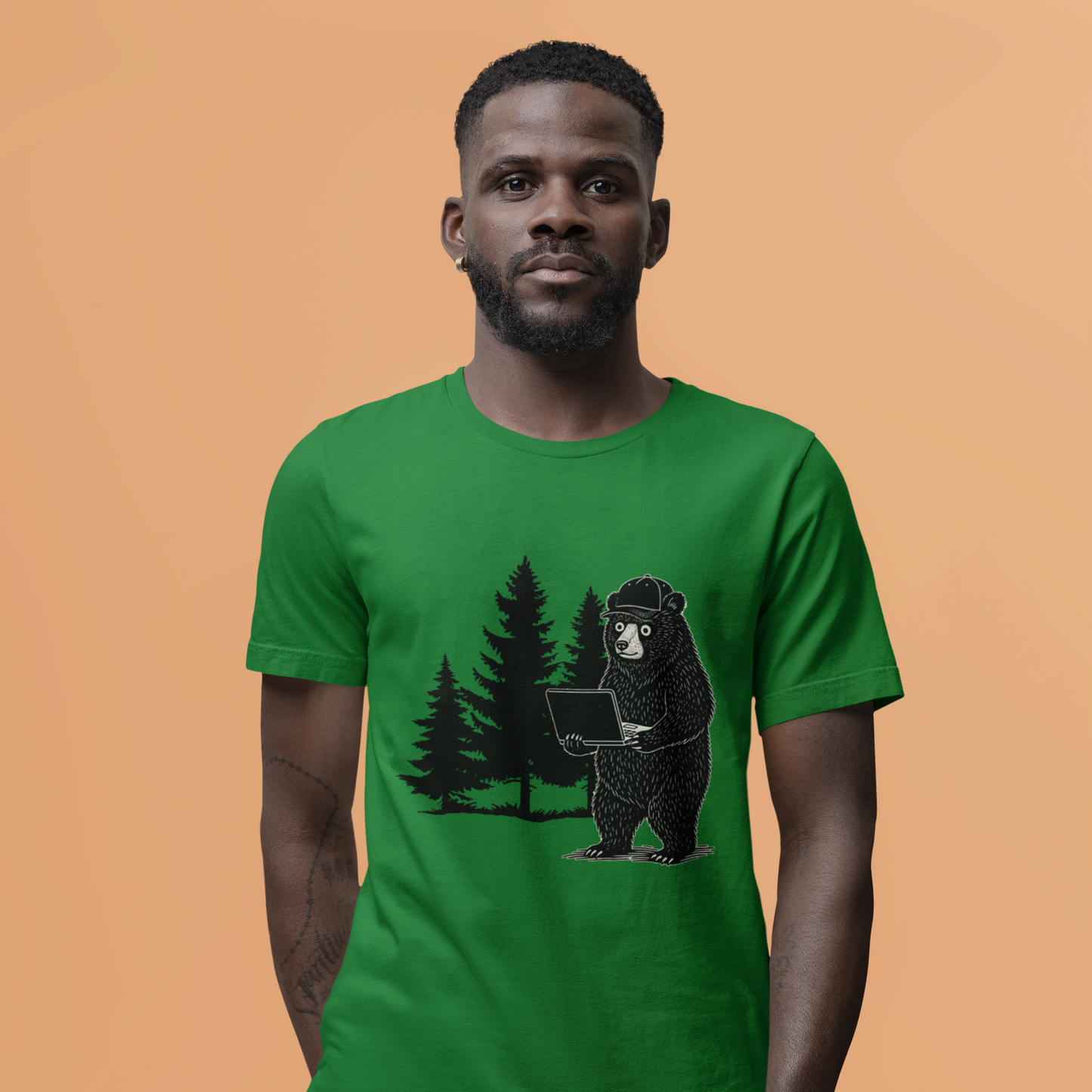 Man wearing a green t-shirt with a bear holding a laptop graphic on an orange background