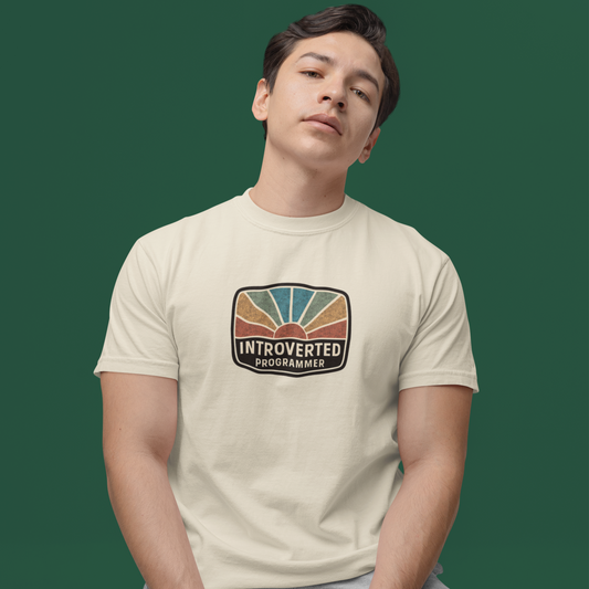 Person wearing a t-shirt with 'Introverted Programmer' design on a green background