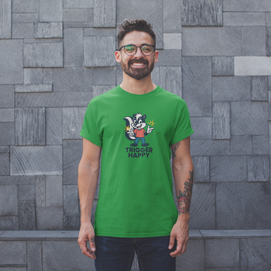 Man wearing a green t-shirt with a graphic design in front of a gray brick wall.