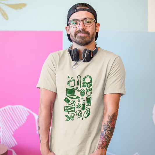 Man wearing a beige t-shirt with green graphics and headphones, standing against a colorful wall.