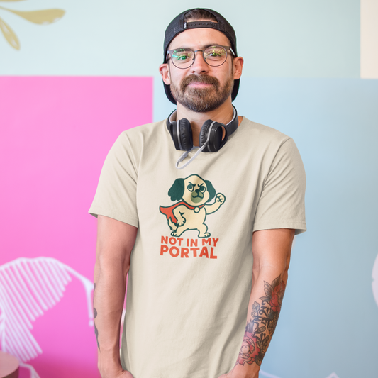 Man wearing a beige t-shirt with a graphic design and text, standing against a colorful background.