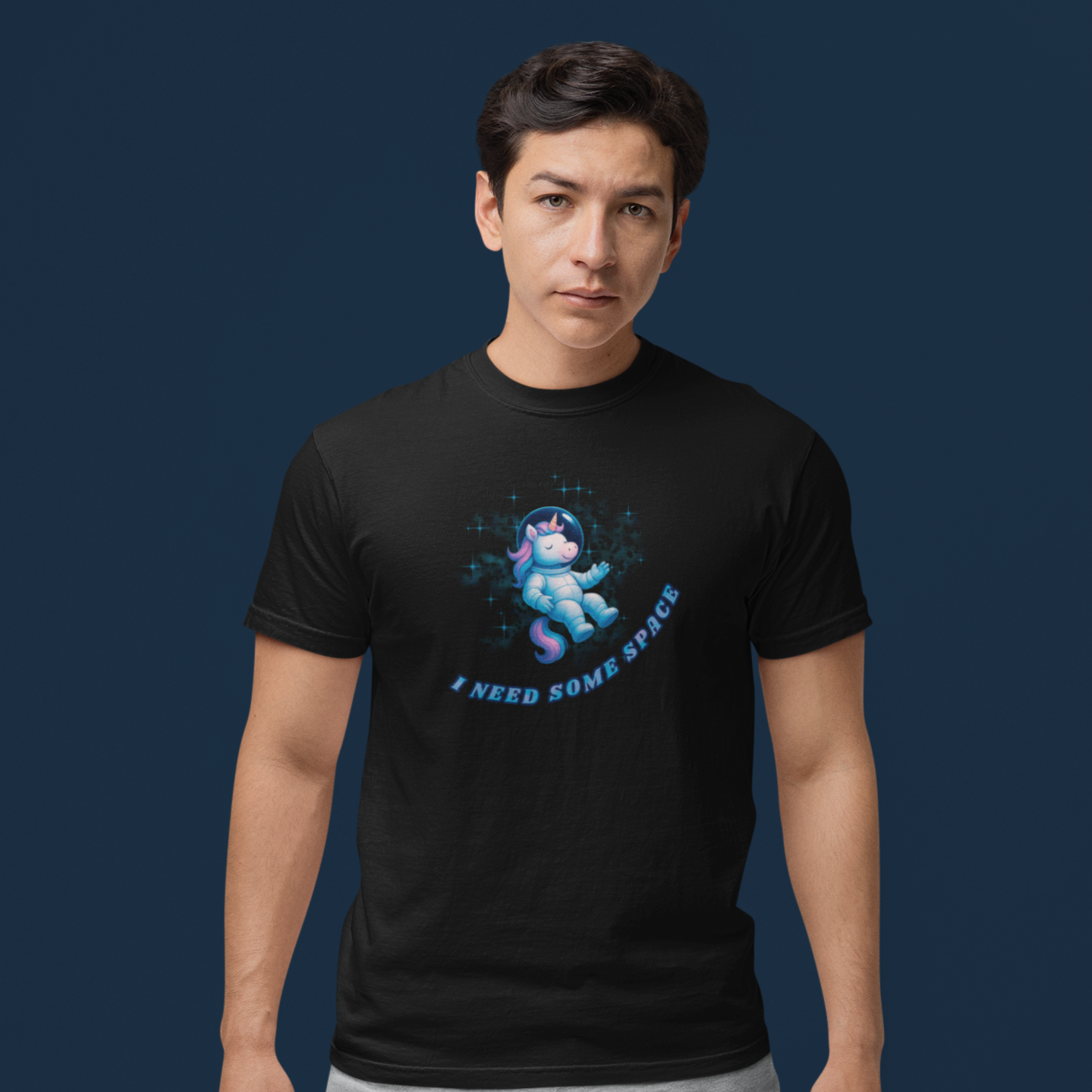 Person wearing a black t-shirt with a graphic design on a dark blue background