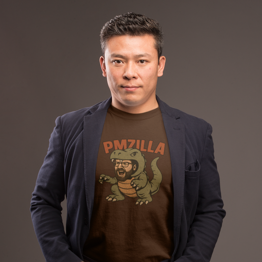 Man wearing a dark blazer over a graphic t-shirt with a logo on a gray background
