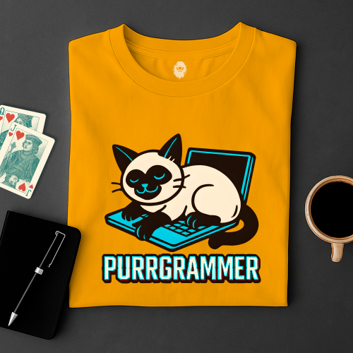 Yellow t-shirt with a cat graphic and 'PURRGRAMMER' text on a dark surface with cards and a mug.