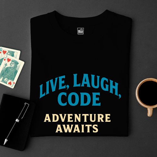Black t-shirt with 'Live, Laugh, Code Adventure Awaits' text on a dark surface with cards and a mug.