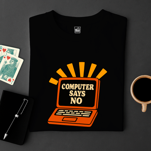 Black t-shirt with 'Computer Says No' graphic on a dark surface with cards and a cup.