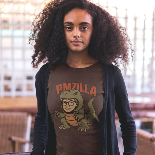 Woman wearing a brown t-shirt with a graphic design and text, standing indoors.