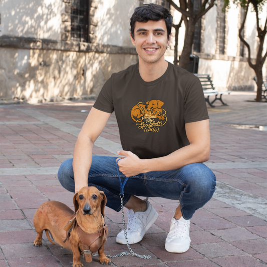 Man wearing a brown t-shirt with a dog graphic, squatting on a brick pavement with a small dog.