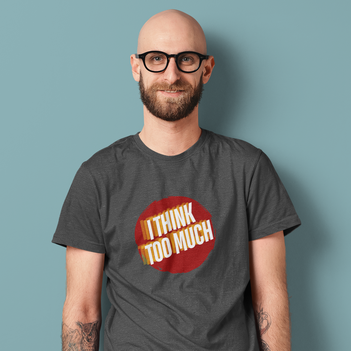 Man wearing a gray t-shirt with a red and yellow graphic and text against a blue background