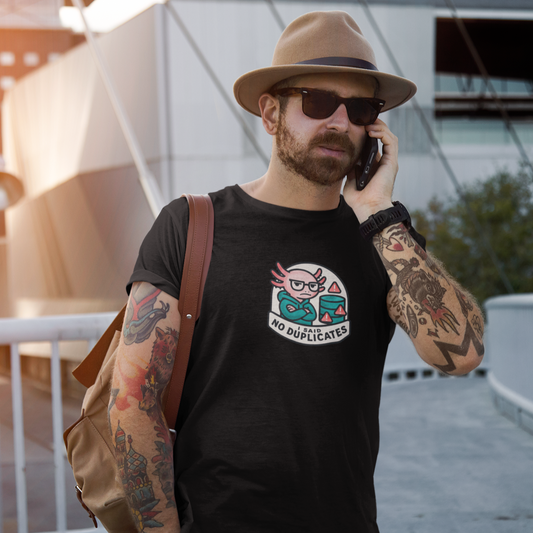 Man wearing a black t-shirt with a graphic design, holding a phone to his ear, standing outdoors.