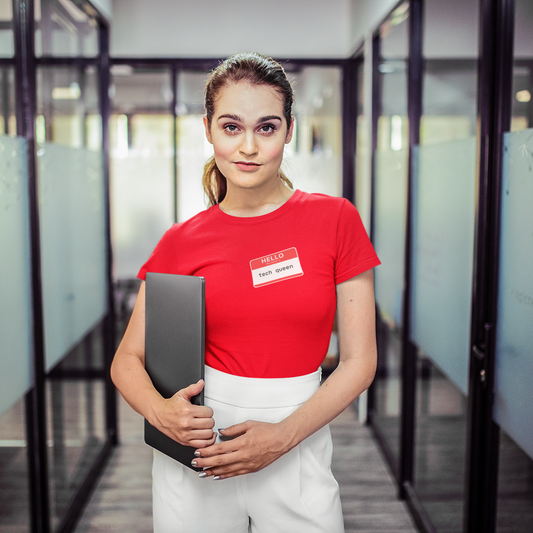 Person wearing a red shirt with a name tag in an office setting